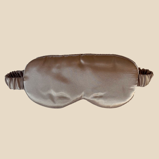 Silky sleep mask on a beige background